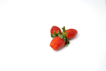 Red and fresh strawberries isolated on white