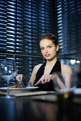 Obraz na płótnie Canvas Woman enjoying her meal in a luxurious restaurant