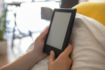 electronic book with empty screen in woman hands