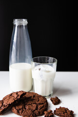pouring milk in glass with chocolate cookies