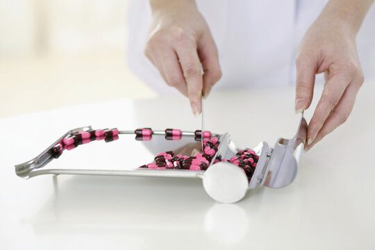 Doctor counting pills on pharmaceutical tray - Powered by Adobe