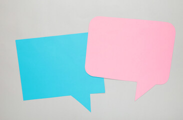 Obraz na płótnie Canvas Dialog - two blank speech bubbles on grey backgrounnd