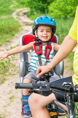 Caucasian joyful happy child have biking helmet on the  bicycle.