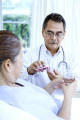 Doctor getting pills for his patient