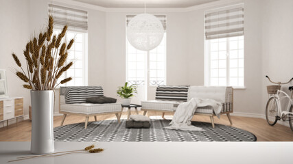 White table top or shelf with straws, dry plants, ornament, ears, sheaf, branch in vase, over white living room with sofa, armchair and carpet, parquet, modern minimal interior design