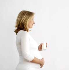 Pregnant woman with a glass of milk