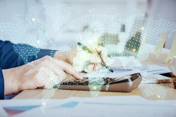 Double exposure of Man writing in notepad with business icons on background.