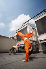 Young man and woman breakdancing