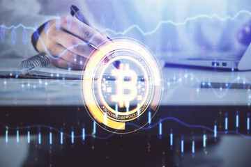 Fototapeta premium Cryptocurrency hologram over woman's hands writing background. Concept of blockchain. Double exposure