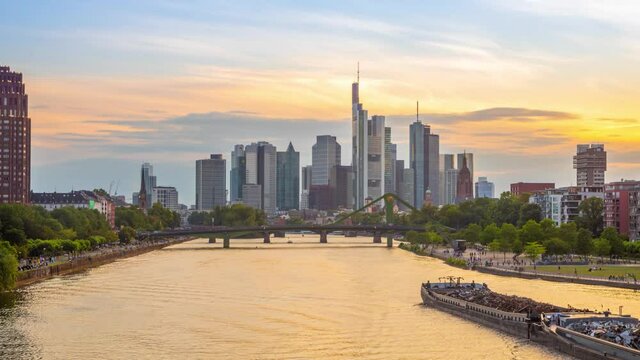 Frankfurt am Main, Germany. Day to night time lapse video with river and skyscrapers
