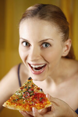 Woman with a slice of pizza