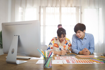 Concept business working and people happy businesses creative female office worker with computers writing to notebook with documents and laptop.