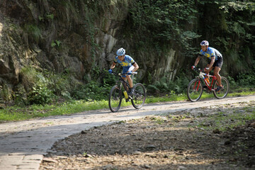 Male cyclists riding on the mountain