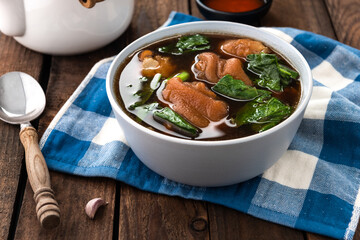 stewed pork leg in bowl on wood