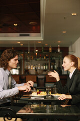 Businessman and businesswoman having a meal in a restaurant