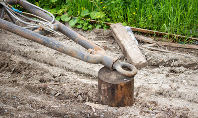 An old rusty trailer and a stump. A trailer for the transport of goods