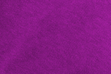 The texture of the purple fabric. The cotton fabric is purple.