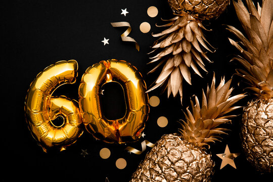 60th birthday celebration background with gold balloons and golden pineapples