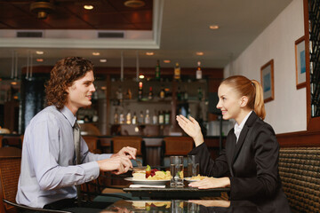 Businessman and businesswoman having a meal in a restaurant