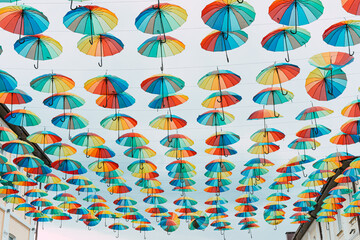 Fototapeta na wymiar Many colorful umbrellas against the sky