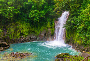 Waterfall and natural pool with turquoise, blue water of Rio Celeste in Tenorio Volcano national park, Costa Rica. Central America.