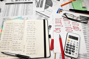 Top view of office employee's desk - work with financial reports, analysis and accounting, tables and graphs, various office items for bookkeeping