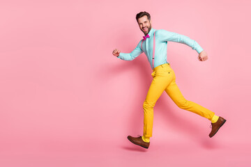 Full length photo of cheerful crazy guy enjoy rejoice discount jump run copyspace wear shirt pants isolated over pastel color background