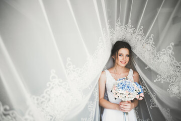 Beautiful bride wearing fashion wedding dress with feathers with luxury delight make-up and...