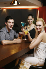 Man and women drinking at a bar