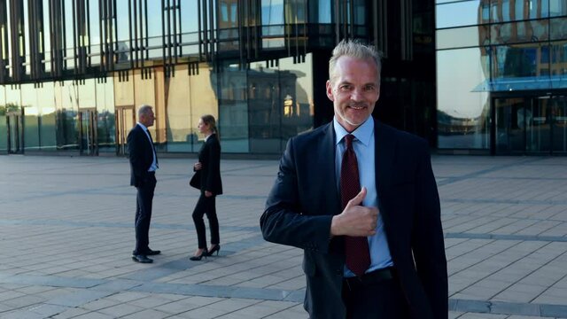 Portrait of young professional businessman team leader in suit shows thumb up look at camera, human resource for best business choice, corporate team portrait