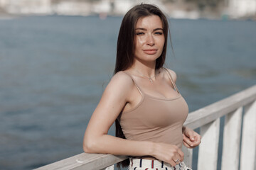 beautiful young smiling woman portrait outdoor near sea, happy face