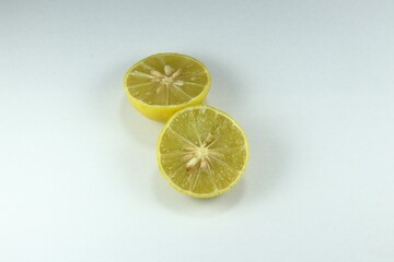 Cutting ripe organic lime with seed on the white background. Main ingredients in Asia cooking food and beverage, sour taste. 