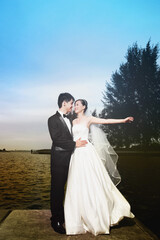 Bride and groom posing outdoors