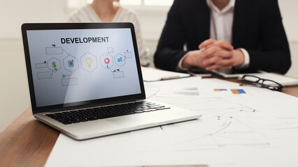 Laptop With Business Development Scheme On Screen In Modern Office