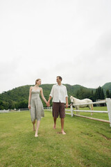 Man and woman holding hands while walking