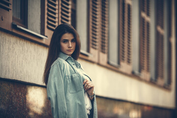 Fashion hipster cool girl relaxing on city street