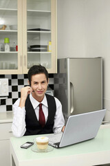 Businessman video conferencing on laptop