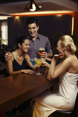 Man and women drinking at a bar