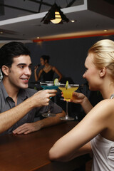Man and woman toasting drinks