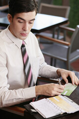 Businessman writing on check