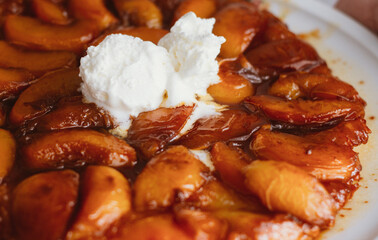 tart with peaches and ice cream close up
