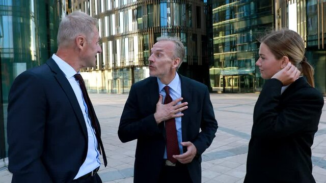 Boss apologizing to colleagues, businessmen praises the work of subordinates, great job, three workers on the break next to office building