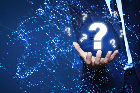 Businessman demonstrating question mark symbol on blue background, closeup