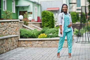 Portrait of African American female doctor with stethoscope wearing lab coat.