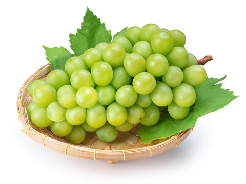 Green grape in Bamboo basket isolated on white background, Shine Muscat Grape with leaves on white background With clipping path, 