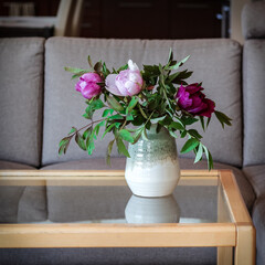 Fresh peonies on a table in a living room