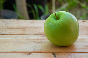 Green apple place on wooden table