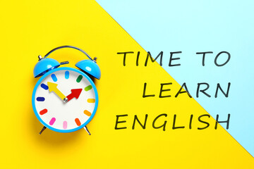 Alarm clock and text Time To Learn English on color background