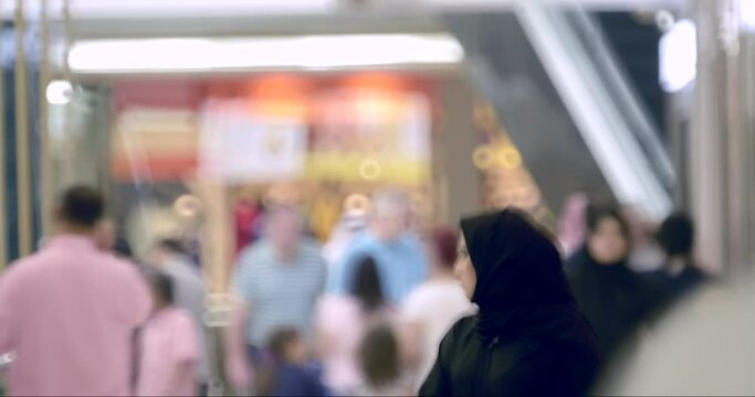 4K Time-lapse of people streaming by in busy shopping center complex in Doha. 