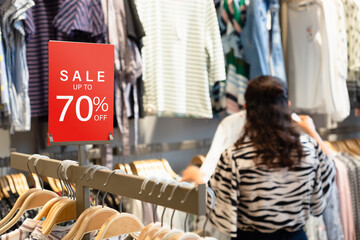 Sale label stand template on shelve in female clothing store for sale promotion and discount...